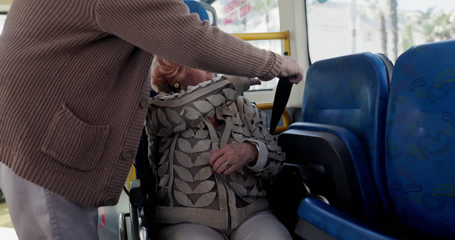 Wheelchair, belt and bus with elderly people for safety, handicap policy and helping. Security, public transportation or love with senior couple with a disability or strap for journey or metro travel