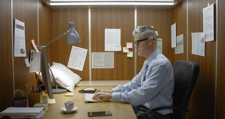 Bored exhausted employee working and sleeping in the same room, he sleeps next to his desk, video montage