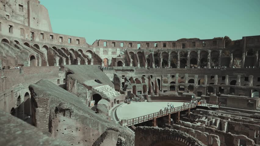 Vibrant energy fills historic Colosseum as tourists explore ruins amid warm sunlight. Ancient stone structures tell stories of gladiators and epic battles.