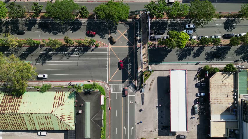 Overhead View Of Cars Driving On The Main Road In Greenhills, San Juan, Metro Manila, Philippines. - aerial shot