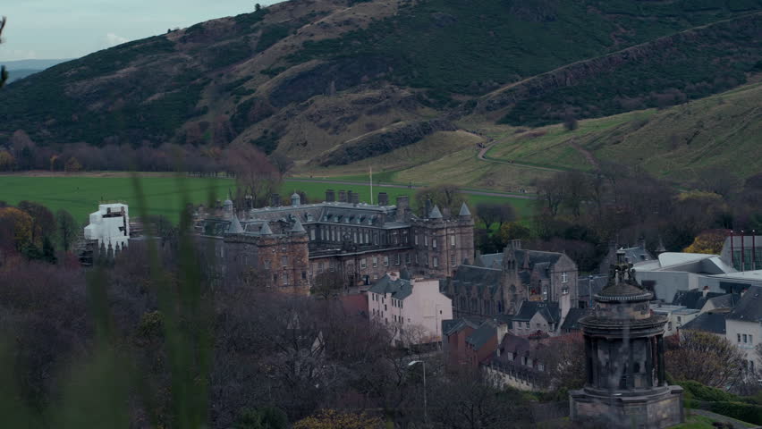 Slow Motion Panoramic View from Calton Hill of Holyrood Palace and Edinburgh Cityscape in Daylight, Scotland.