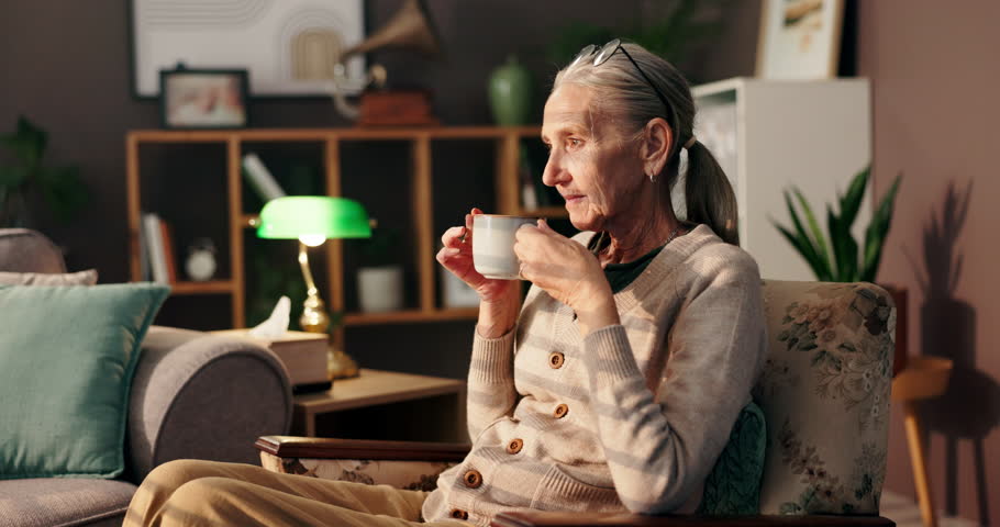 Relax, thinking and coffee with old woman on sofa for peace, reflection and caffeine beverage. Happy, calm and memory with senior person and mug in living room at home for tea, aroma and comfortable