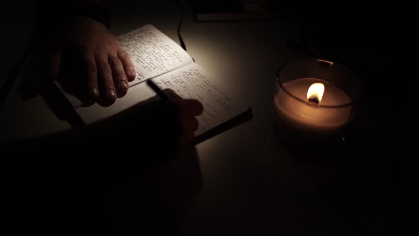 man journaling his thoughts into notebook, because he has some sort of depression, problems and want to find out and help himself without psychologist