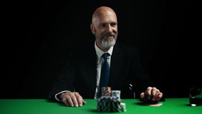 Smiling businessman going all-in during poker game, pushing stacks of chips - Powered by Shutterstock - Get 15% off with code: PIKWIZARD15