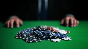 Businessman grabbing all poker chips, winning hand and celebrating victory - Powered by Shutterstock - Get 15% off with code: PIKWIZARD15