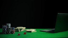 Online casino scene with poker chips, money, dice, and laptop on table, gambling - Powered by Shutterstock - Get 15% off with code: PIKWIZARD15
