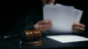 Judge working with legal papers in courtroom, gavel on desk, judicial system - Powered by Shutterstock - Get 15% off with code: PIKWIZARD15
