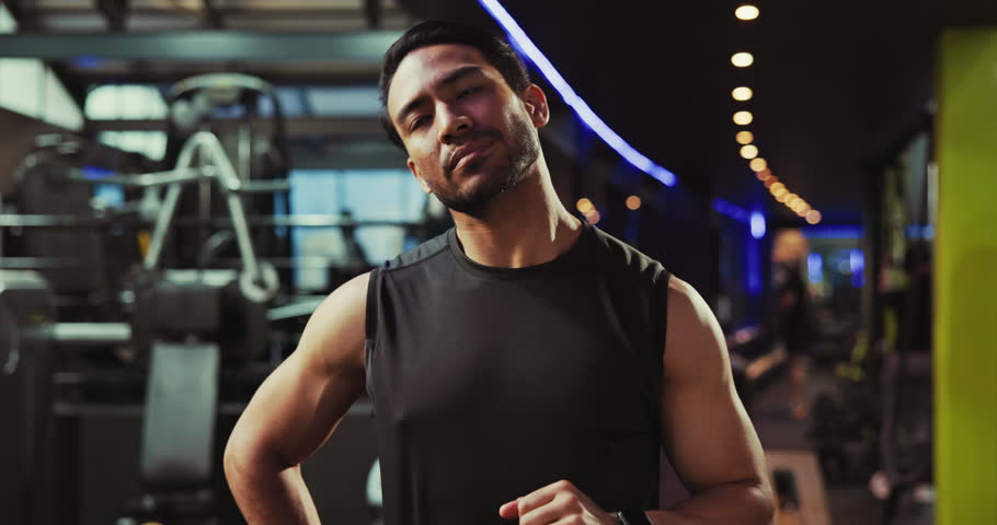 Bodybuilder, fitness and man in gym, training and challenge with endurance, energy and workout. Asian person, athlete and exercise in wellness center, warm up and breathing with routine and health