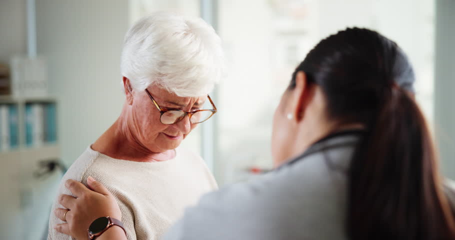 Consultation, upset and senior woman with doctor for diagnosis with bad news in hospital. Comfort, sad and healthcare worker with elderly female patient for support with medical results in clinic.