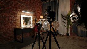 Backstage. A professional photographer captures a model in a chic studio with a fashion-centric setting, complete with a vanity mirror and stylish outfits. - Powered by Shutterstock - Get 15% off with code: PIKWIZARD15
