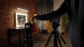 Backstage. A professional photographer captures a model in a chic studio with a fashion-centric setting, complete with a vanity mirror and stylish outfits. - Powered by Shutterstock - Get 15% off with code: PIKWIZARD15