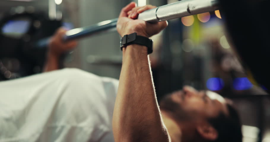 Exercise, barbell and man in gym, hands and challenge with training, endurance and energy. Person, athlete and equipment in wellness center, power or health with fitness, weightlifting or body muscle