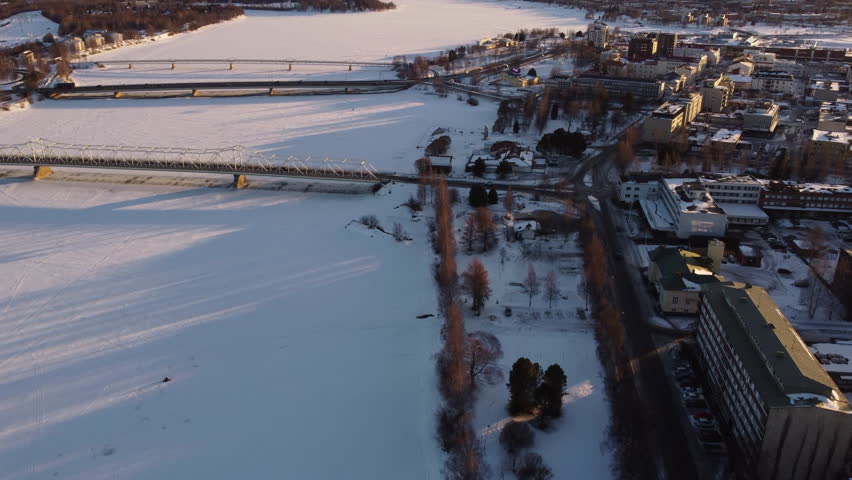 Bridges over frozen and snowy Torne River, Tornio City in winter, Finland. Aerial