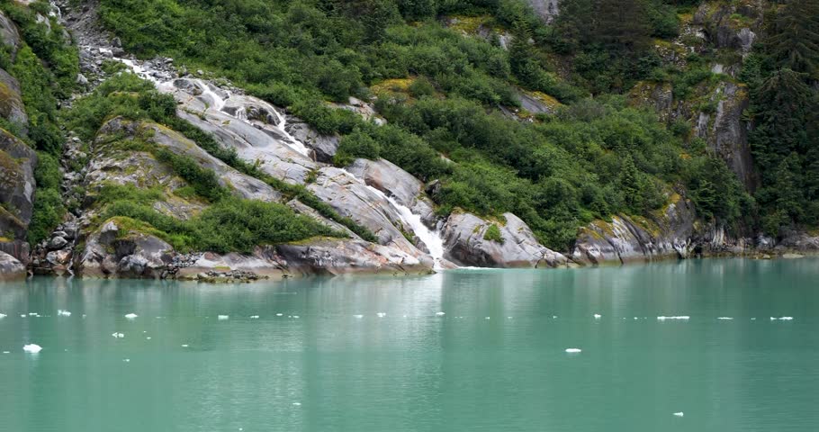 Base of waterfall in Endicott Arm fjord, where pristine glacial meltwater plunges into tidewater, Alaska.