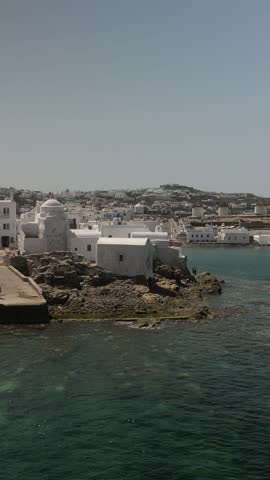 A tranquil view of Mykonos, showcasing its stunning coastline and characteristic white buildings.