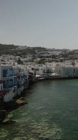 A tranquil view of Mykonos, showcasing its stunning coastline and characteristic white buildings.
