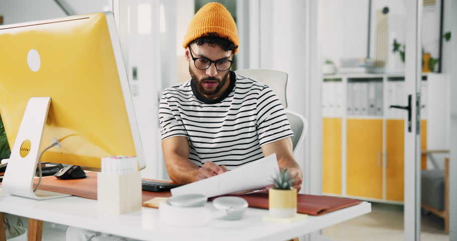 Businessman, computer or document at desk for creativity, article editing or review in creative office. Journalist, typing or tech in agency for website update, topic research or paper for planning