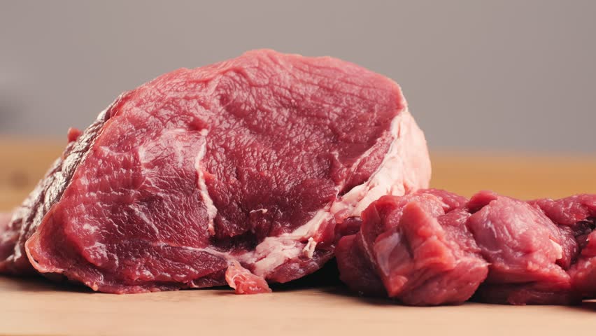 Man cut meat steak, beef pork neck cooking, Cook Butcher. The chef cuts the meat for cooking. Neck carbonate with vegetables cutting on ktchen for bbq grill, marinade. 