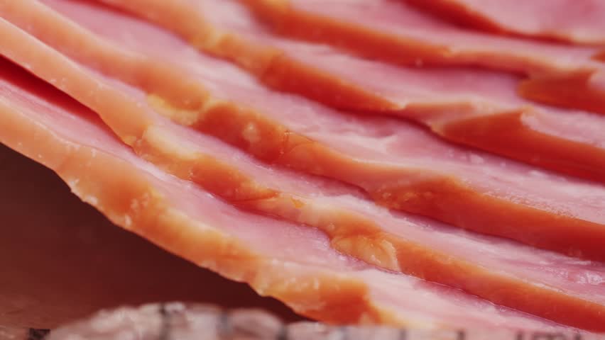 Raw pork bacon in black plastic pack isolated on white background. Streaky brisket slices, fresh thin sliced bacon, food ingredient