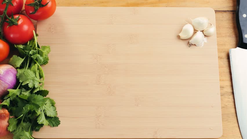 Man slicing raw turkey or chicken meat fillet on oak cutting board closeup, cooking with knife on restaurant kitchen.