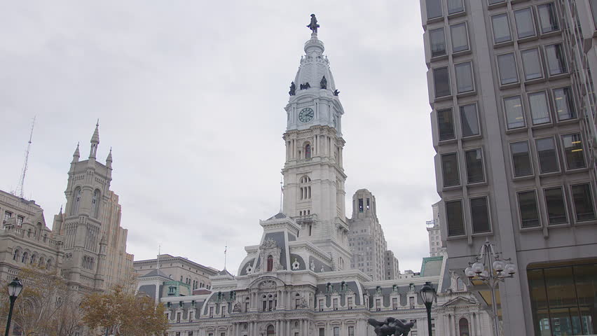 Slow-motion view of Philadelphia’s majestic City Hall with the iconic statue of Ben Franklin atop the clocktower, showcasing historic architecture and the grandeur of the city’s civic centerpiece.