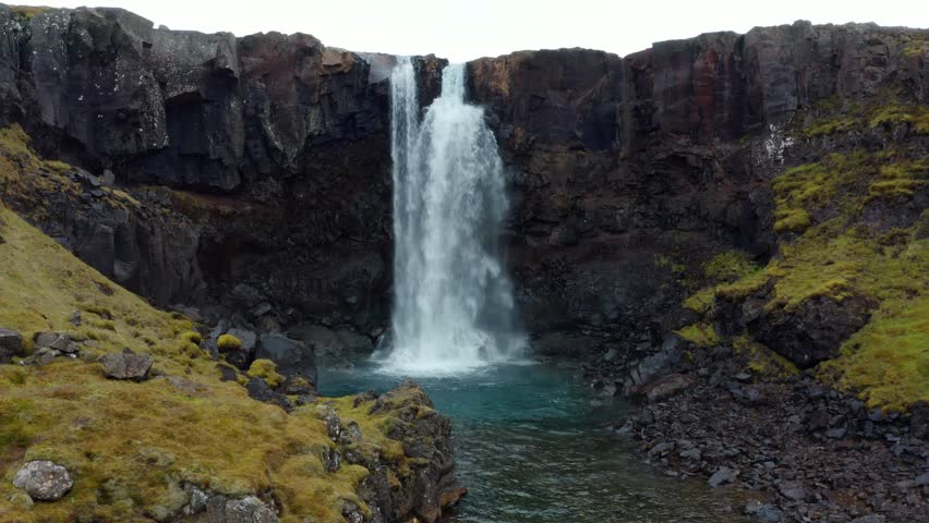 4k drone flight moving to the side footage (Ultra High Definition) of Gufufoss (Gufu Waterfall). Midnight sun scene of typical volcanic landscape of Iceland. Beauty of nature concept background.
