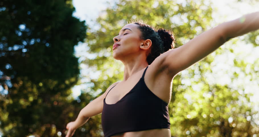 Yoga, praying hands and girl with meditation by park for mindfulness, holistic healing and calm energy. Zen, below and peaceful woman in nature with namaste, wellness and breathing for mental health