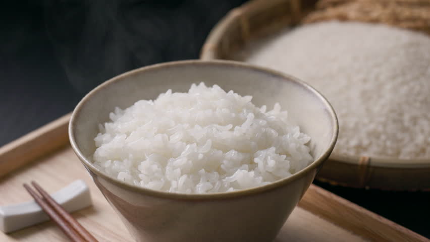 Steaming Japanese white rice served in a rice bowl