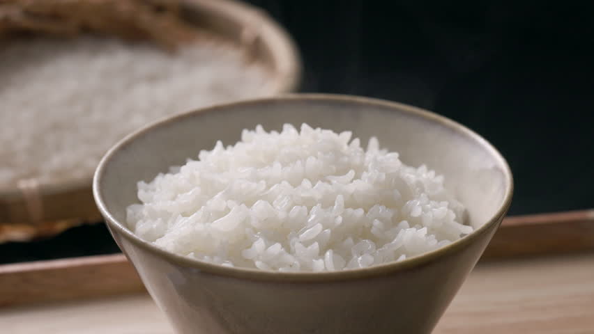 Steaming Japanese white rice served in a rice bowl