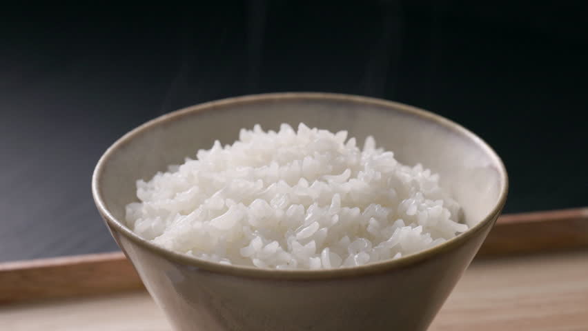 Steaming Japanese white rice served in a rice bowl