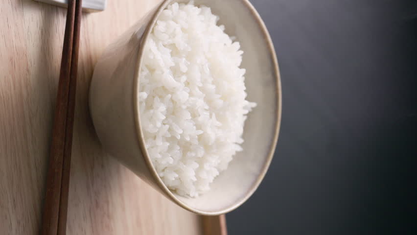 Steaming Japanese white rice served in a rice bowl