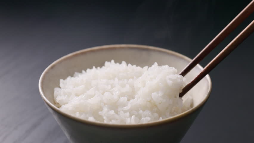 Steaming Japanese white rice served in a rice bowl