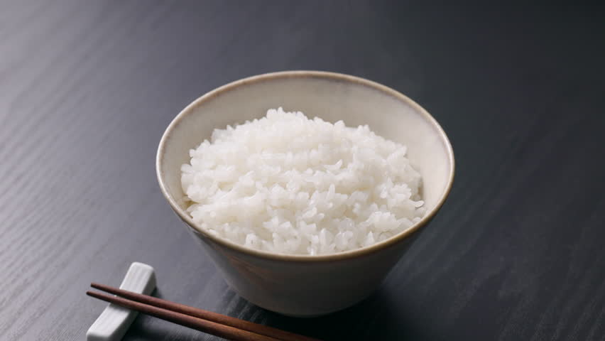 Steaming Japanese white rice served in a rice bowl