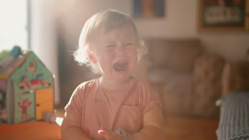 Parenting issues. Close up portrait of upset cute american baby boy crying in fathers hands, feeling stressed and annoyed, tracking shot, slow motion