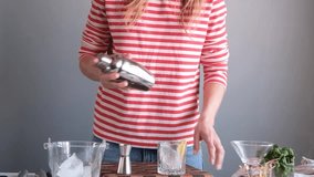 woman making alcohol cocktail in home kitchen - Powered by Shutterstock - Get 15% off with code: PIKWIZARD15