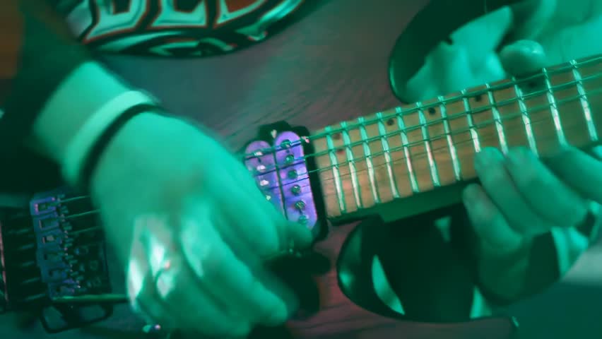 Live band playing very fast metal music. Energetic electric and bass guitar performance on stage. Intense rock music show.