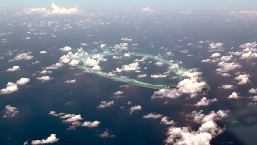 4k Aerial video footage, flying along Horsburgh Atoll with Goidhu Island, Fulhadu and Fehendhu. The oval shaped Atoll with lagoon and  island forest at Baa atoll, located at Maldives in Indian Ocean