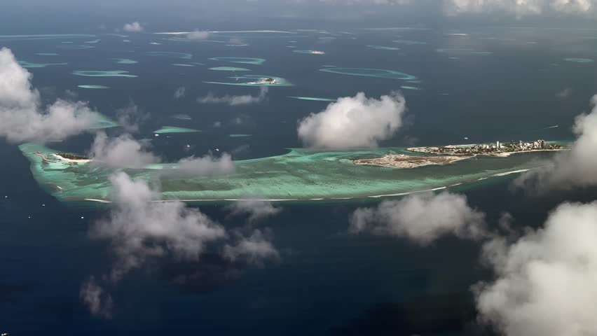 4k Aerial video footage, flying along the Island of Maafushi. The Atoll with lagoon and islands is located on the  Kaafu atoll, Maldives in Indian Ocean
