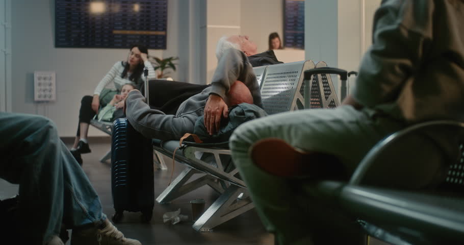 Crowded International Airport Terminal: Exhausted Man with Luggage Sleeping on the Seats in Boarding Lounge of Airline Hub. Diverse People and Passengers Waiting for Delayed Flight. Tourism and Travel