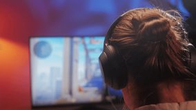 Young man has a video game stream or podcast in neon room. Male gamer playing online video games on his personal computer. - Powered by Shutterstock - Get 15% off with code: PIKWIZARD15