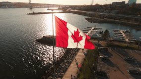 An Aerial View of the Canadian Flag Flying on the Dartmouth Waterfront with the Skyscrapers of Halifax in the Background. The Flag Waves in the Wind, Representing Canada Strength and Beauty. - Powered by Shutterstock - Get 15% off with code: PIKWIZARD15