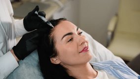 Trichologist performing hair loss injection treatment for woman - Powered by Shutterstock - Get 15% off with code: PIKWIZARD15