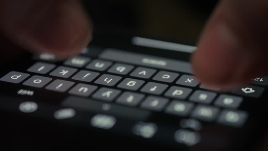A person types on a smartphone note app with auto-suggestions appearing on the screen