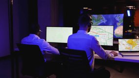 Two dispatchers tracking truck movements on multiple screens - Powered by Shutterstock - Get 15% off with code: PIKWIZARD15
