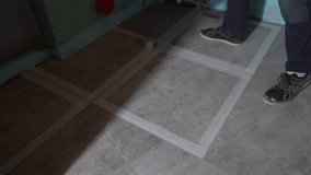 After grouting the ceramic tile joints. The masking tape is removed from the floor. Cleaning after renovation. High quality 4k footage - Powered by Shutterstock - Get 15% off with code: PIKWIZARD15