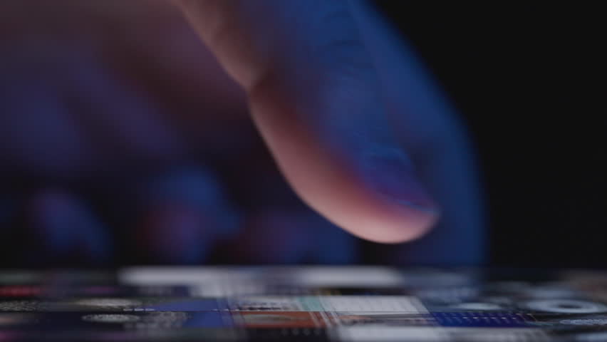 A hand scrolling through photo thumbnails on a mobile device, browsing a digital gallery