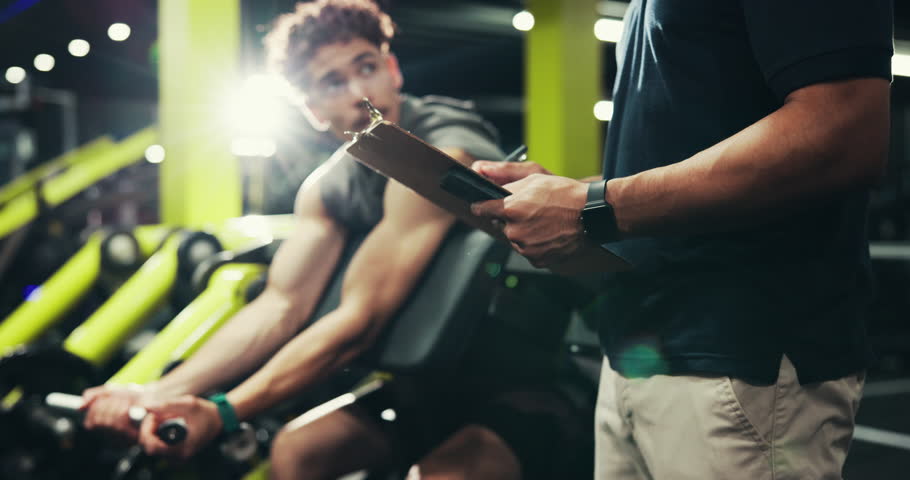 Power, trainer and man with machine, gym and exercise for wellness, clipboard and writing progress. Health club, instructor and person with fitness for body, routine and bodybuilder with strength