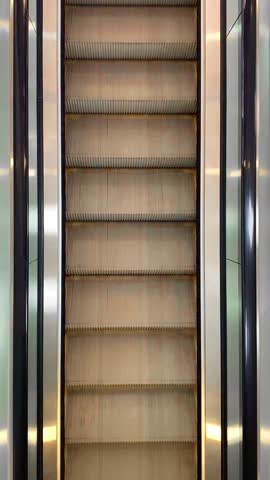 Empty moving escalator in a shop mall. Top view. Close-up.