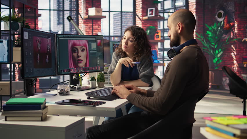 Graphic designer and photographer collaborate in a modern studio, using AI powered photo editing software on PC. Providing automation, retouching and advanced image adjustment tools. Camera A.