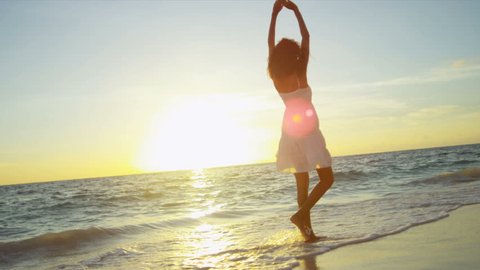 Happy Latin American girl having fun beach on luxury island at sunrise shot on RED EPIC